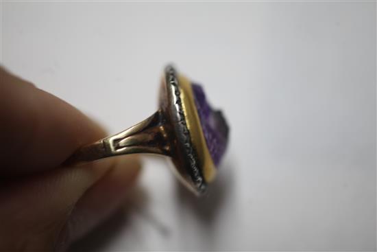 A 19th century amethyst glass? oval cameo ring, with rose cut diamond set border, (adapted?), size M.